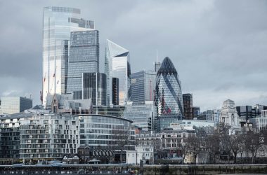 Modern multistory business centers with geometric architecture located on street against cloudy sky in downtown of London city in financial district