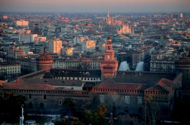 A stunning aerial photo of Milan featuring Castello Sforzesco and sunset colors.